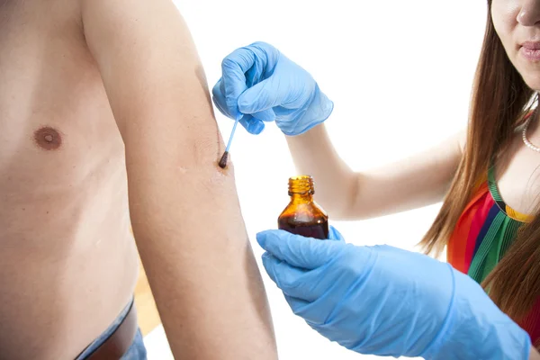 Nurse applying  iodine — Stok fotoğraf