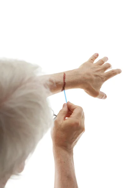 Male hand applying iodine — Stockfoto