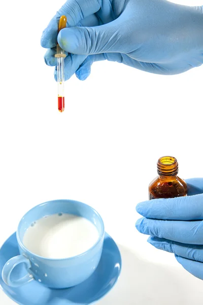 Doctor Hands with liquid in glassware — Stock Photo, Image