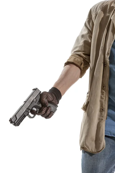Человек в черной перчатке с пистолетом — стоковое фото