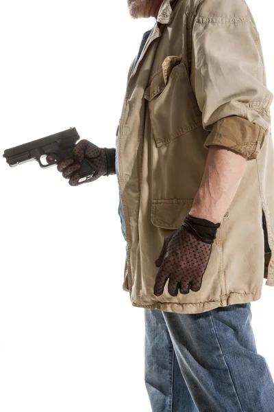 Man i svarta handskar med en pistol — Stockfoto