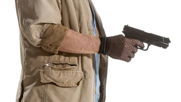 Homem de luvas pretas com uma arma — Fotografia de Stock