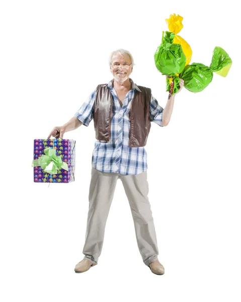 Senior man with candies and gift bag — Stock Photo, Image