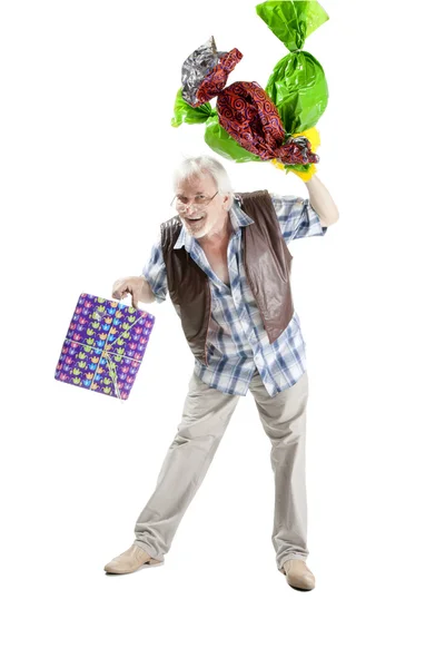 Senior man with candies and gift bag — Stock Photo, Image