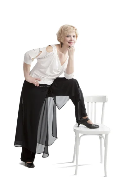 Woman posing beside the chair — Stock Photo, Image