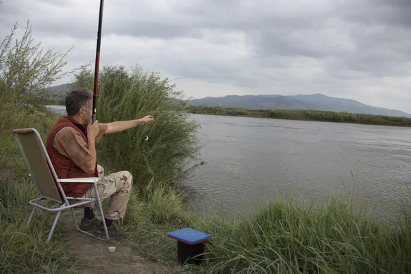 Fisherman fishing on a river — Stock Photo, Image