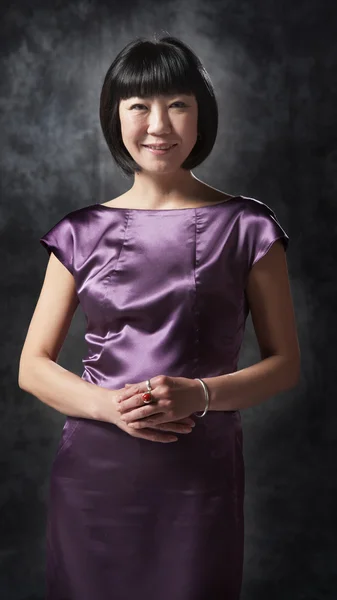 Asian woman in purple dress