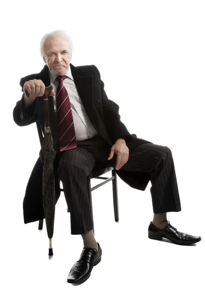 Старший бизнесмен с зонтиком — стоковое фото