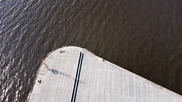 Sunny day by the water with no people or ships around in the harbor. Aerial view of an empty harbor dock. Photo taken in Vsters, Sweden.