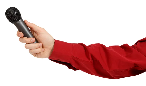 La mano del hombre en una camisa roja sosteniendo un micrófono — Foto de Stock