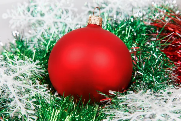 Christmas red ball with garlands and white snowflakes — Stock Photo, Image