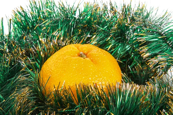 Yellow tangerine on green garland — Stock Photo, Image