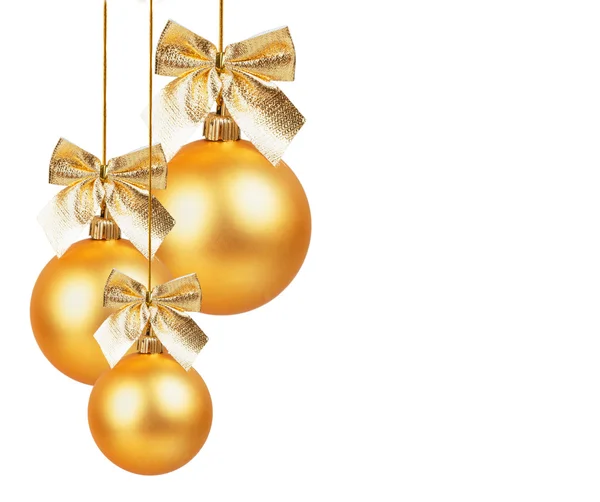 Three gold Christmas balls with golden bow — Stock Photo, Image