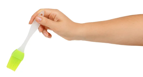 Силиконовая кисть в женской руке — стоковое фото
