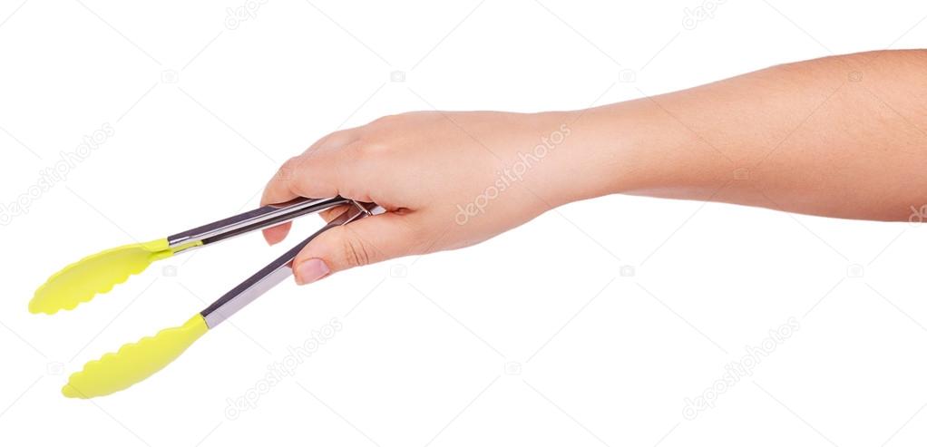 Cooking tongs in female hand