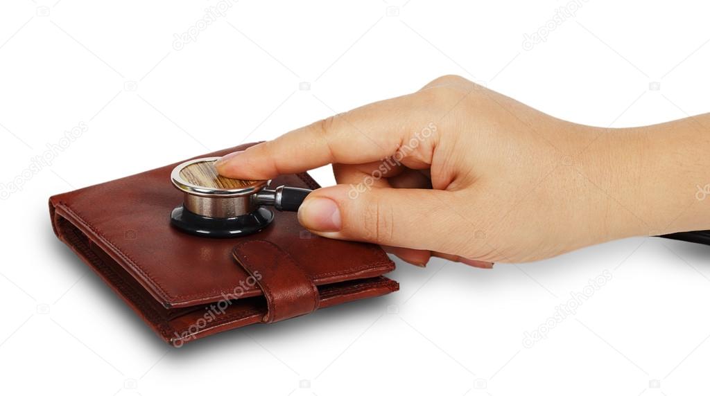 Female hand holding blood pressure meter on a purse