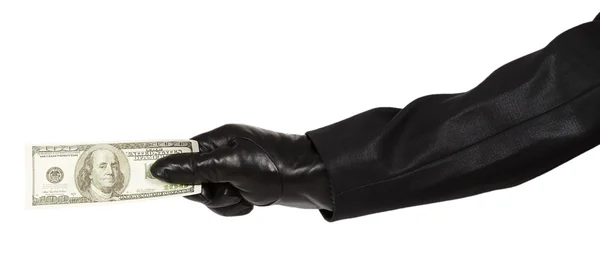 Hand in black glove holding money — Stock Photo, Image