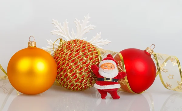 Santa Claus with Christmas balls and white snowflake — Stock Photo, Image