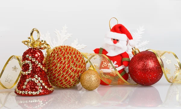 Santa Claus with Christmas balls and white snowflakes — Stock Photo, Image