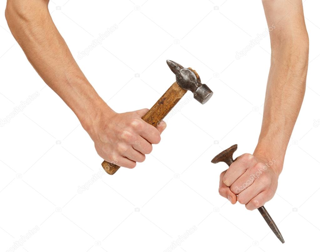 Male hands working with hammer and chisel