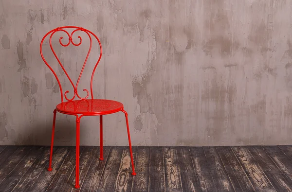 Red metal chair in nterior room