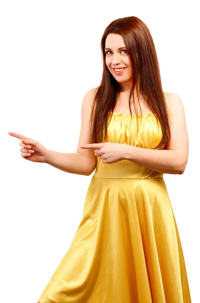 Joven sonriente mujer en amarillo vestido punto dedo mostrando somethi —  Fotos de Stock