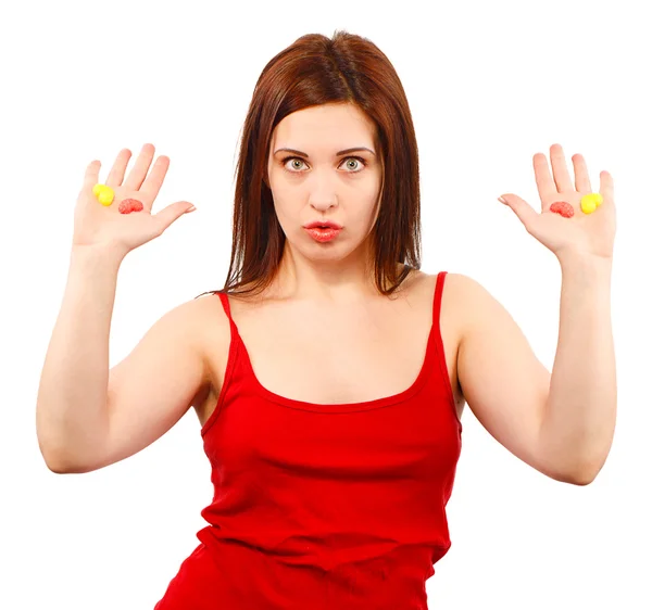 Mujer en rojo con dulces en la mano abierta —  Fotos de Stock