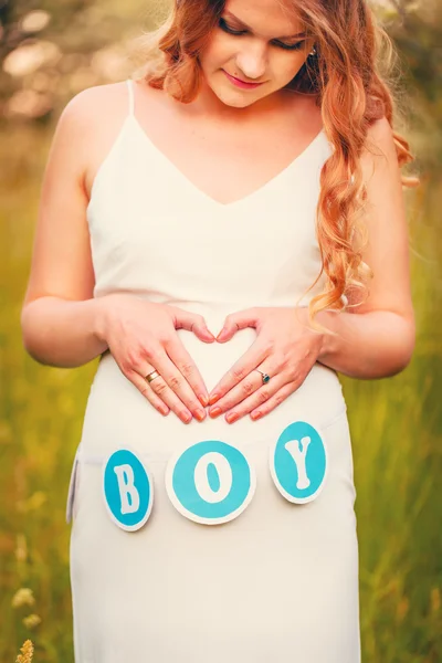 Pregnant woman in a white dress close up — Stock Photo, Image