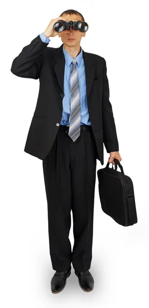 Деловой человек в костюме с сумкой и биноклем — стоковое фото