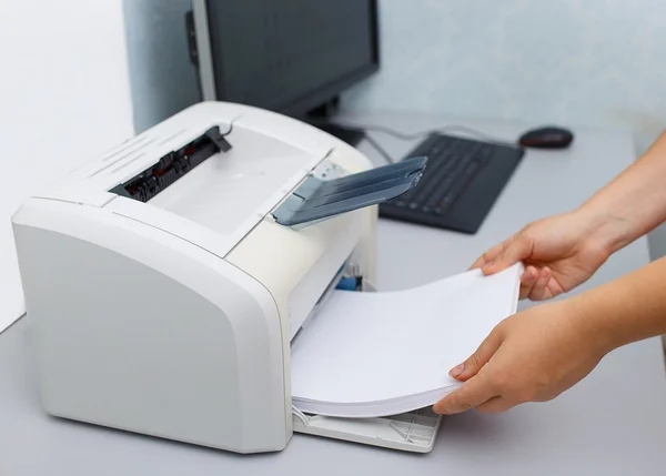Woman's hand with working copier — Stock Photo, Image