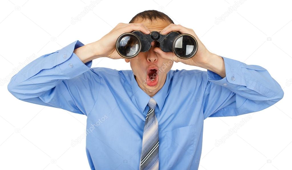 Shocked business man with blue tie with binoculars