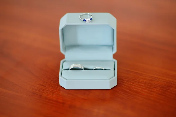 Pair of platinum wedding rings in the box and ring with diamond — Stock Photo, Image