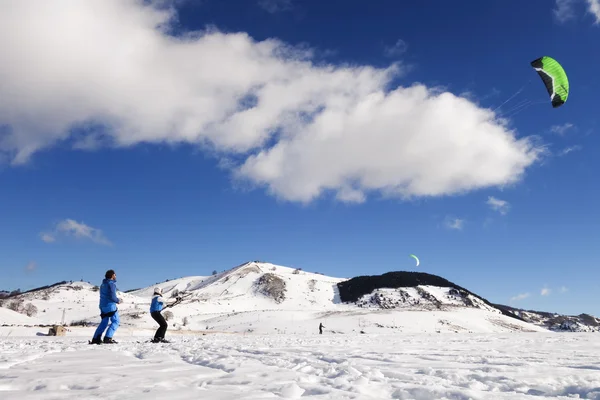 Snowkiting lessons in a snow-covered valley