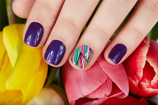 Nails with beautiful manicure and tulip flowers