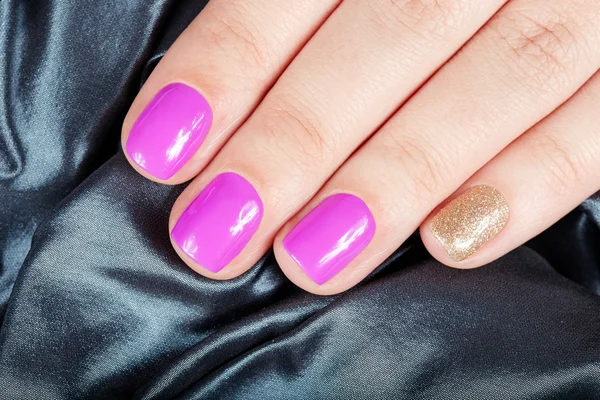 Manicured nails covered with pink and gold nail polish — Stock Photo, Image