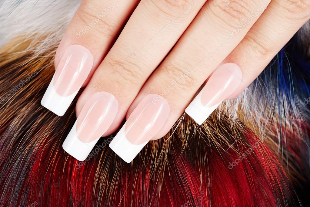 Hand with long artificial french manicured nails on fur background Stock  Photo by ©natkin_zu 110669984