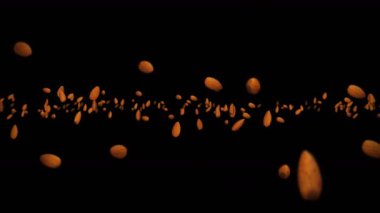 Siyah arka planda bir sürü badem cevizi uçurmak. Yiyecekler, sağlıklı yiyecekler, diyet. Badem dönüşünün 3 boyutlu animasyonu. Döngü canlandırması.