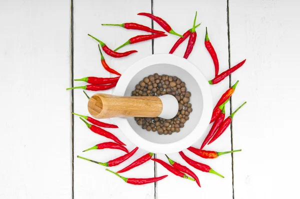 Ceramic mortar and red hot pepper on wooden background — Stock Photo, Image