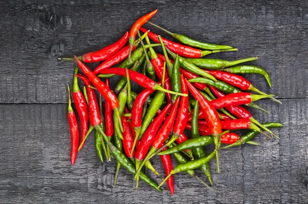 Heap of hot peppers on wooden background — Stock Photo, Image