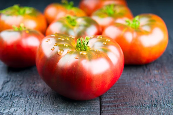 Fresh tomatoes on wooden background — Stock Photo, Image