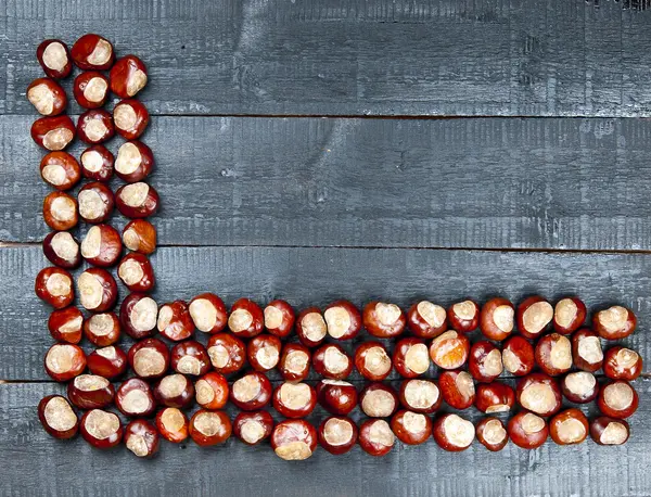 Chestnuts on wooden background — Stock Photo, Image