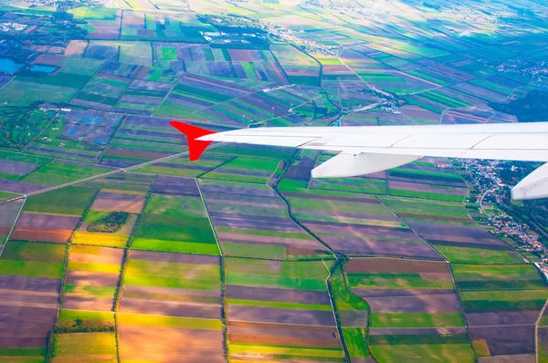 Colorful fields under  wing of the plane — Stock Photo, Image