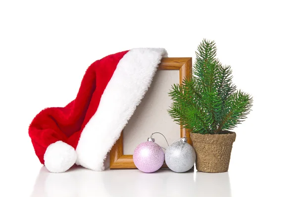 Papai Noel chapéu pendurado na moldura de madeira — Fotografia de Stock