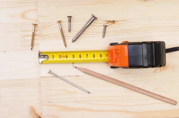 Tape measure on a wooden deck — Stock Photo, Image