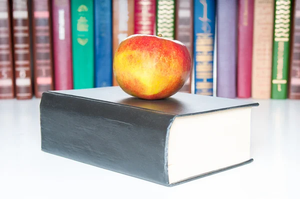 Books with apple on white background — Stock Photo, Image