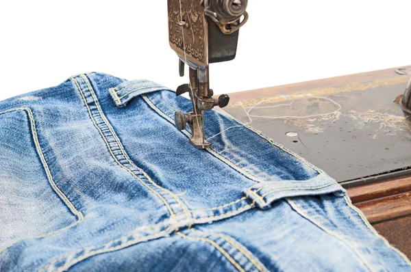 Sewing machine and blue jeans fabric Royalty Free Stock Photos