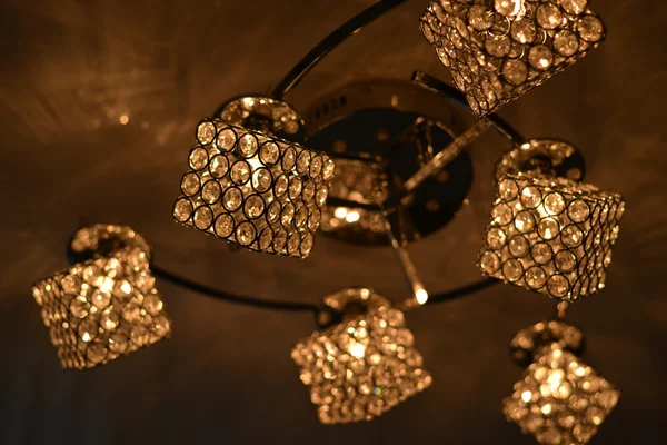 Chandelier with square lights on the ceiling.