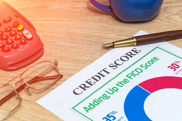 Credit score form on office desk with elegant pen and payment terminal. Business ide