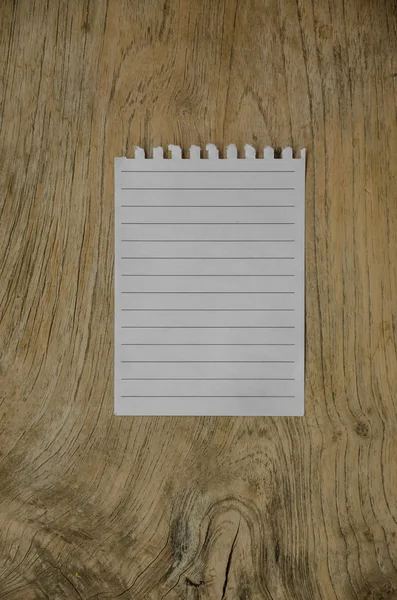 Notebook paper on wood background — Stock Photo, Image