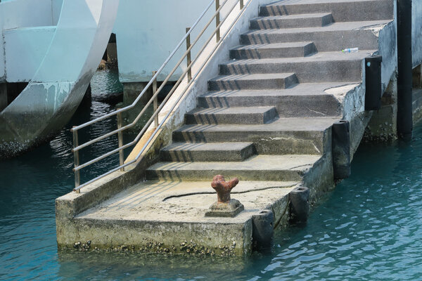 iron mooring a boat to a pier.